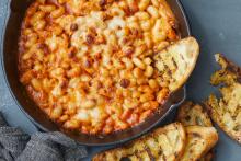 cheesey white bean bake in a pan with bread