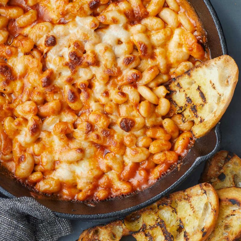 cheesey white bean bake in a pan with bread