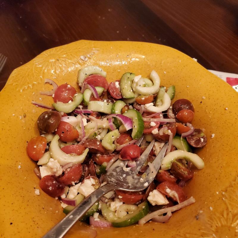 summer salad with cherry tomatoes, cucumbers, red onion, and feta cheese