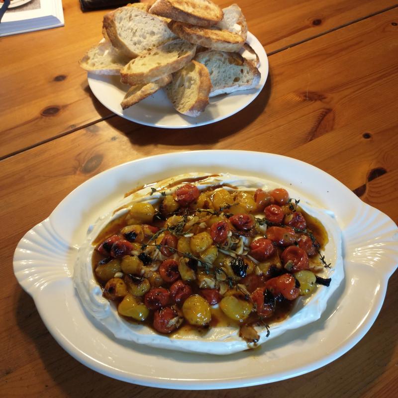 Cherry tomatoes over yogurt